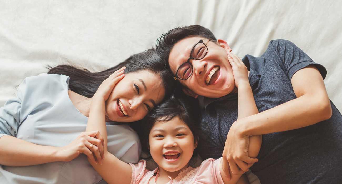 Family cuddling and smiling